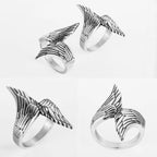 Four silver wing-shaped rings on a white background