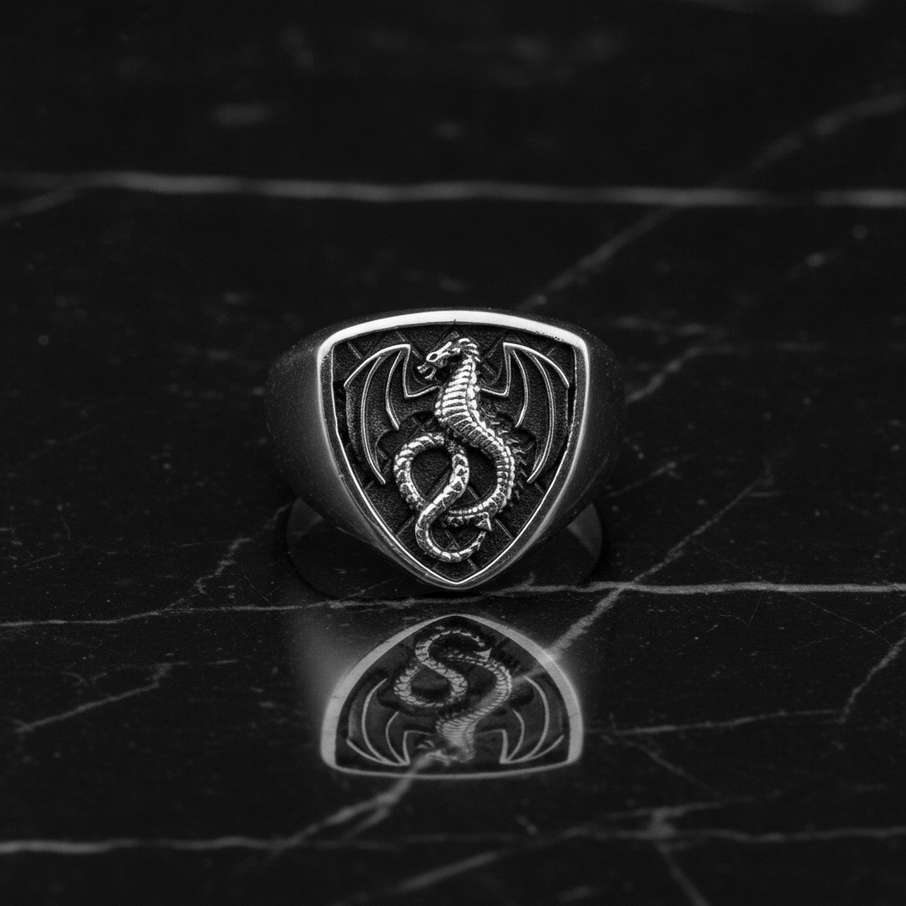 Silver dragon emblem ring on a dark marble surface