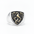 silver an gold ring with dragon design on a white background