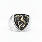 silver an gold ring with dragon design on a white background