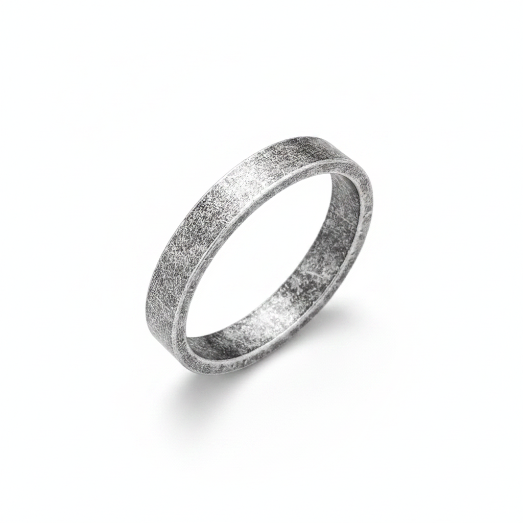 Silver ring with a textured surface on a white background