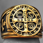 Gold ring with intricate religious design and symbols on a grey background