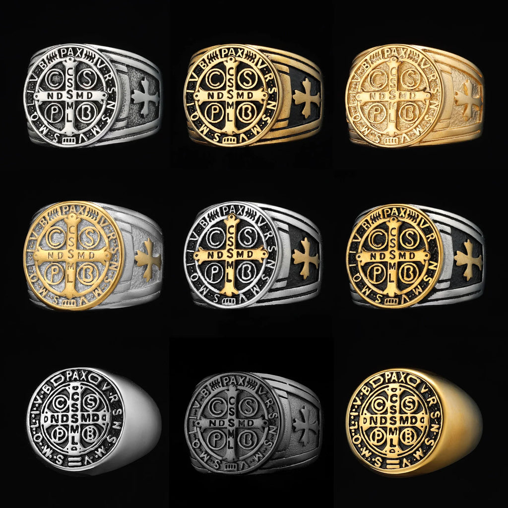 Collection of gold and silver rings with religious Saint Benedict CSPB Cross symbols on a black background