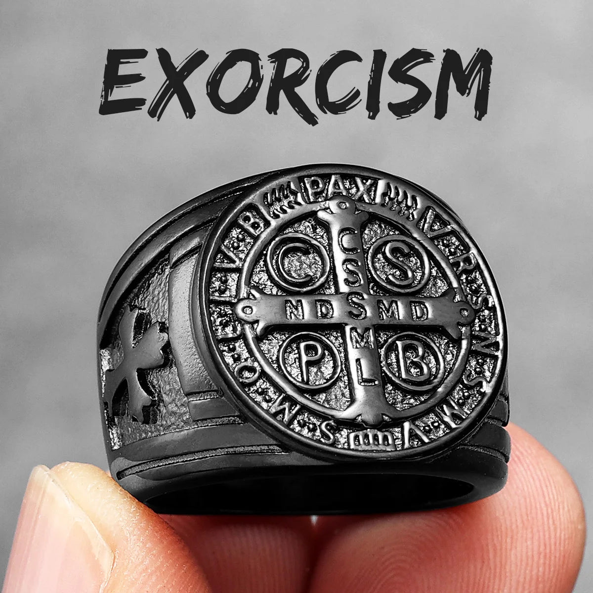 Black and silver exorcism ring held in a hand with a grey background and 'EXORCISM' text.