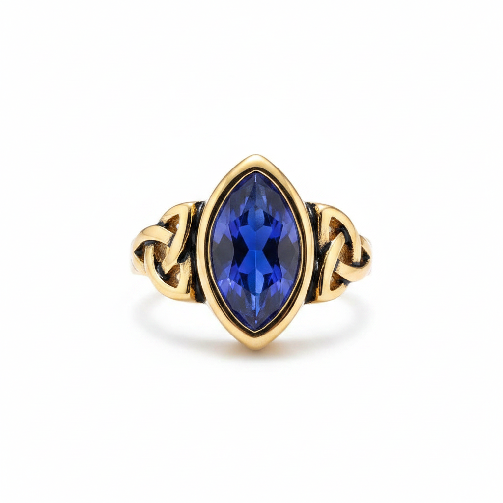 Gold elven themed ring with a blue gemstone on a white background