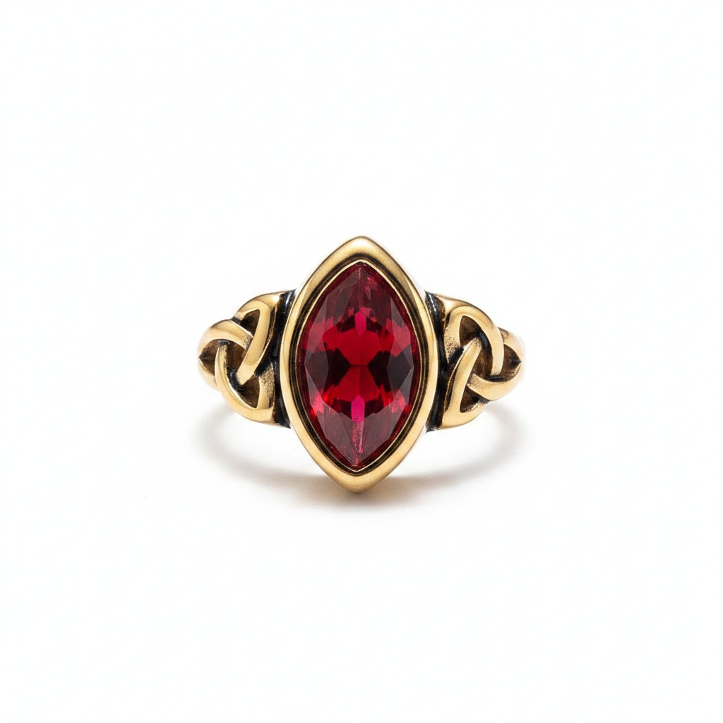 Gold elven themed ring with a red gemstone on a white background