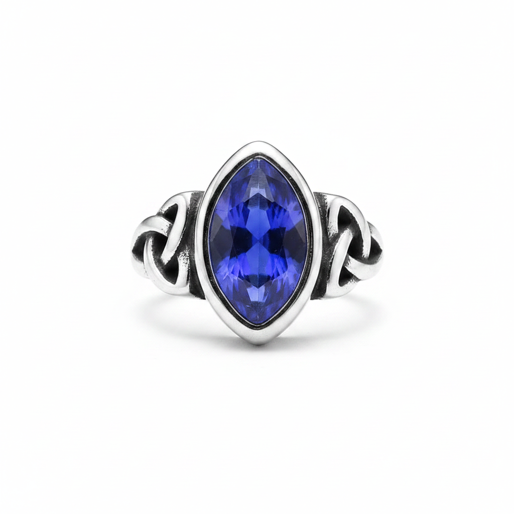 Silver elven themed ring with a blue gemstone on a white background
