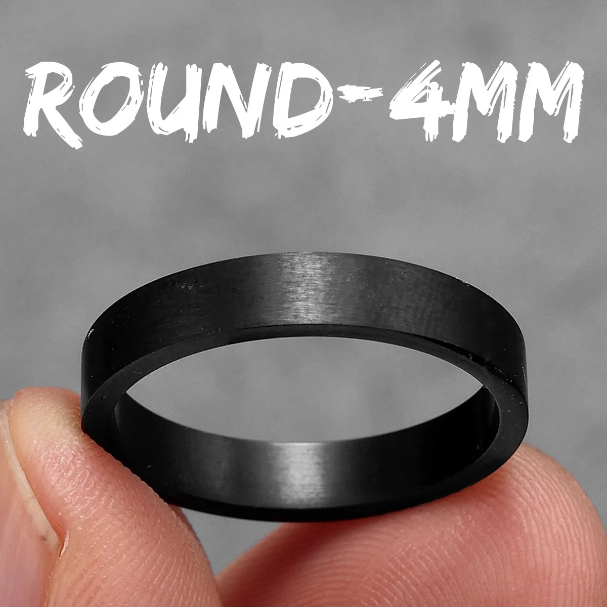 Black ring held between fingers with 'ROUND-4MM' text above on a grey background