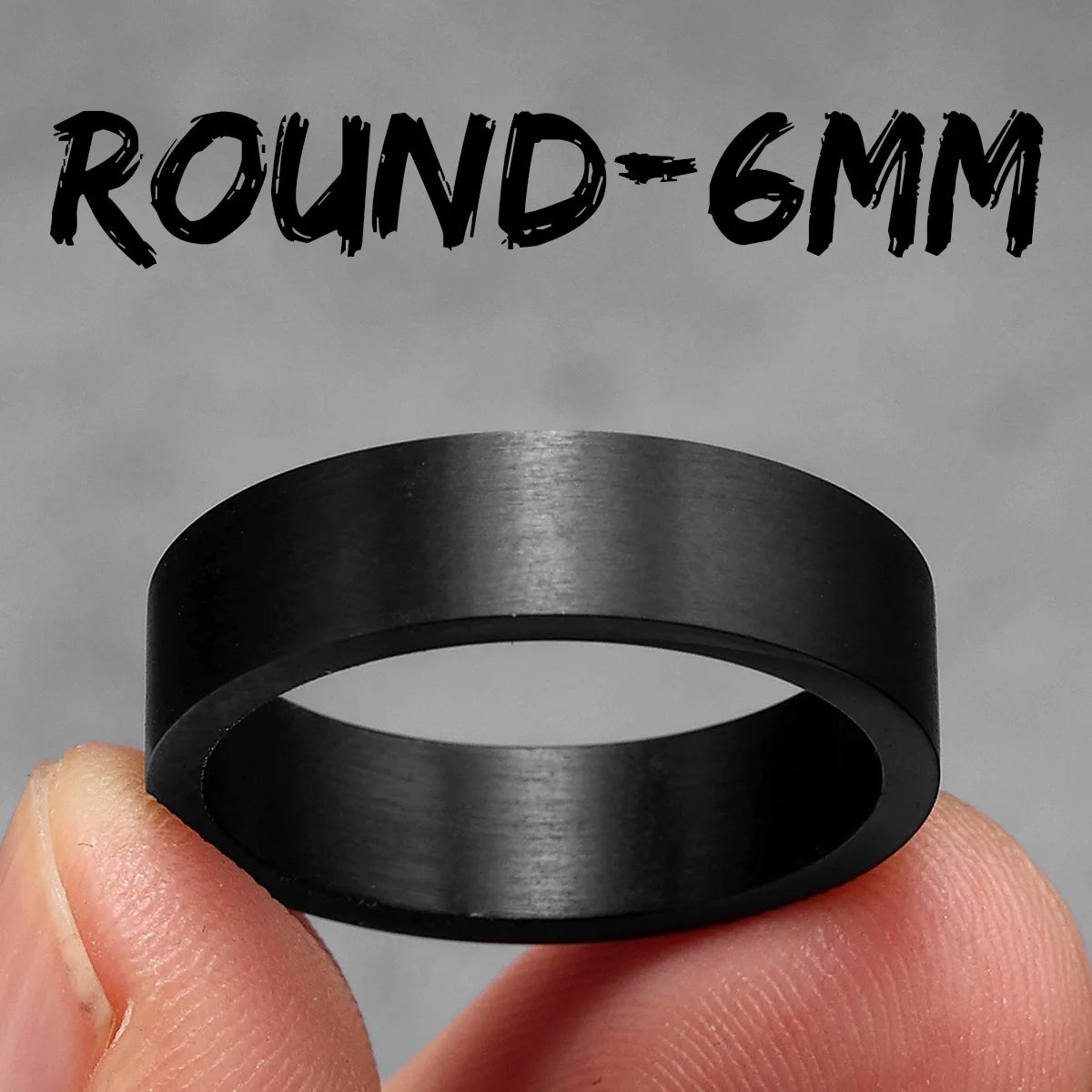 Black ring held between fingers with 'ROUND-6MM' text on a grey background