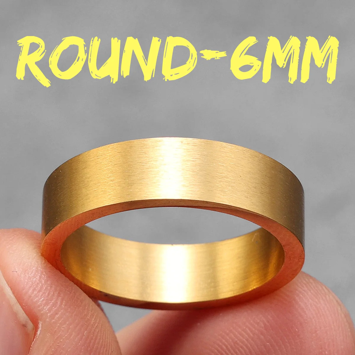 Gold ring held between fingers with 'ROUND-6MM' text above on a grey background