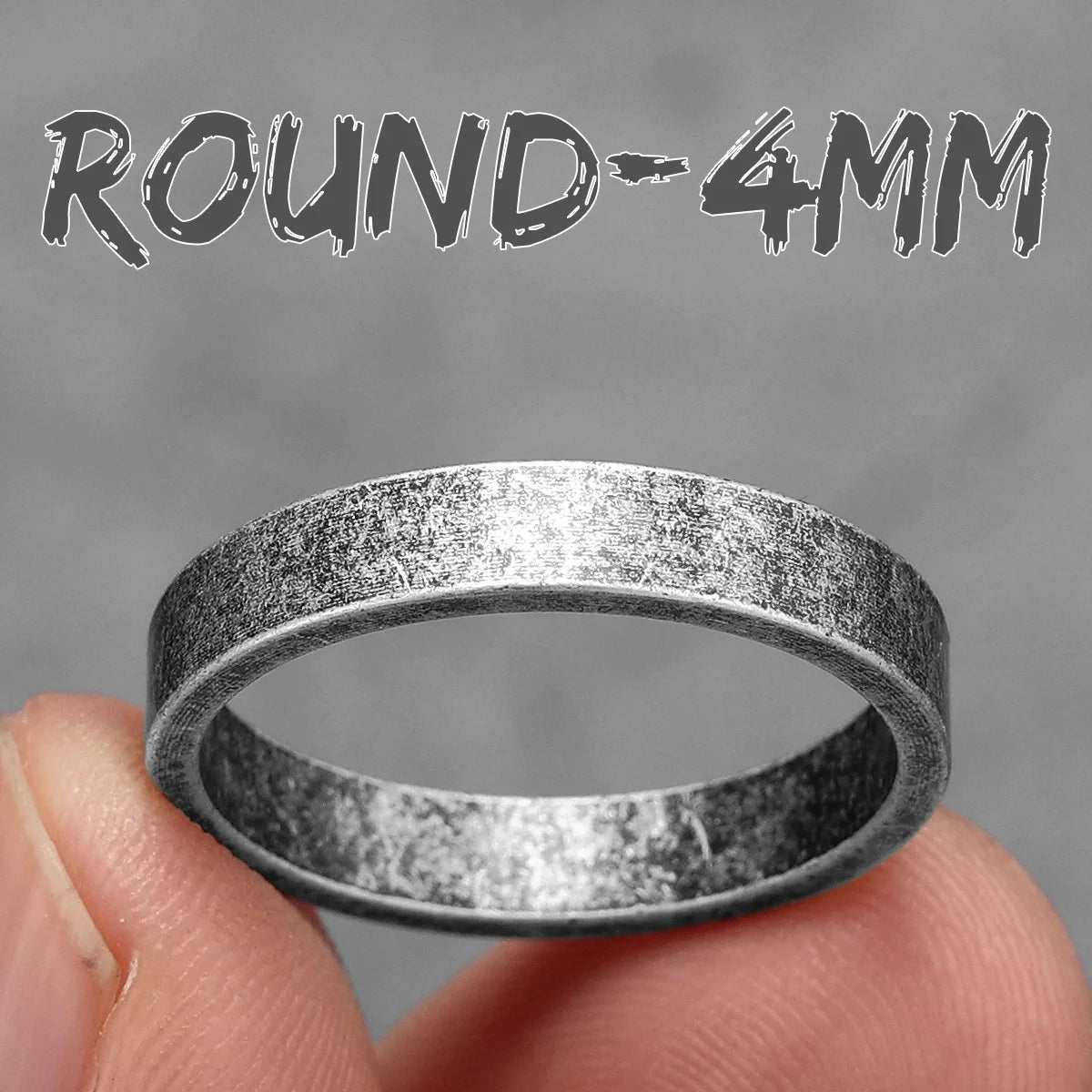 Silver ring held between fingers with 'ROUND-4MM' text above on a grey background