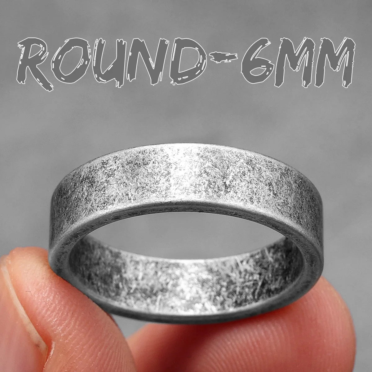 Silver ring held between fingers with 'ROUND-6MM' text on a grey background
