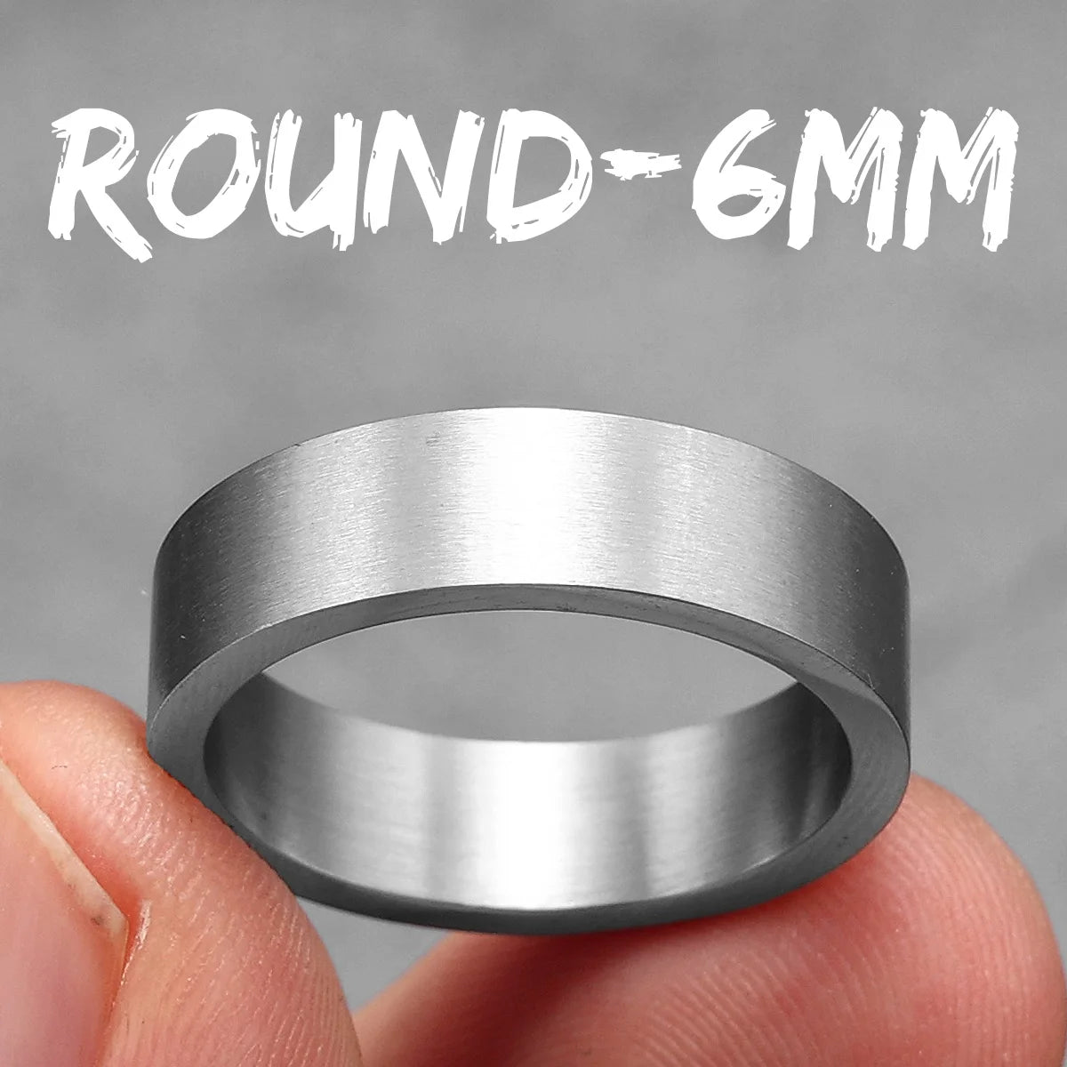 Silver ring held between fingers with 'ROUND-6MM' text above on a grey background