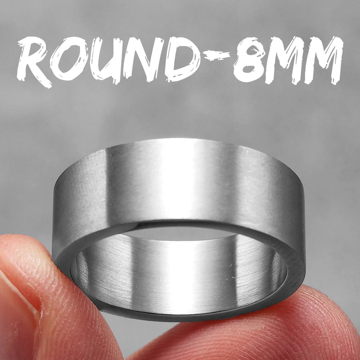 Silver ring held between fingers with 'ROUND-8MM' text above on a grey background