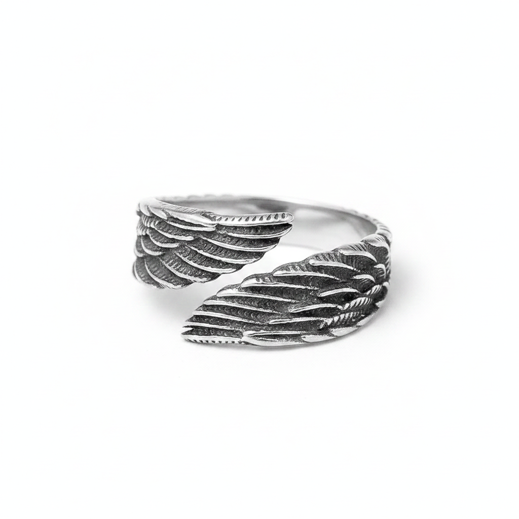 Silver stainless steel ring with feather design on a white background