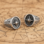 Two silver rings with star designs on a vintage map background