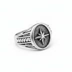 Silver ring with star design on a white background