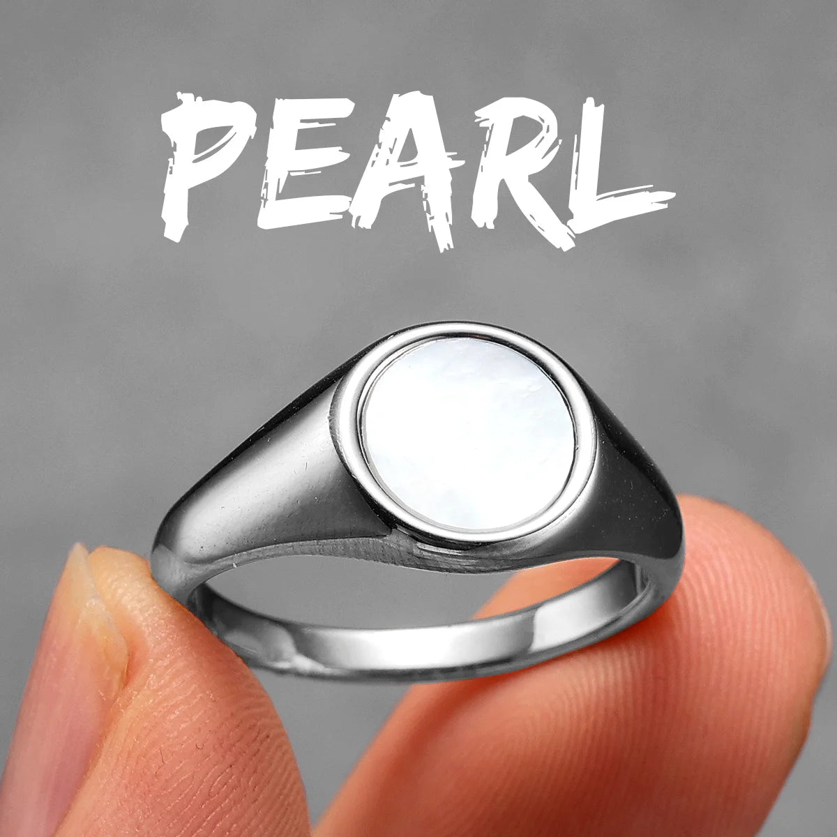 Silver ring with a pearl on a grey background
