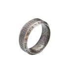 Light grey ring with intricate runic designs on a white background