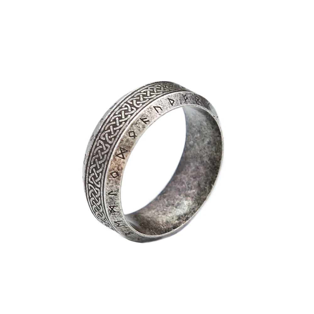 Light grey ring with intricate runic designs on a white background