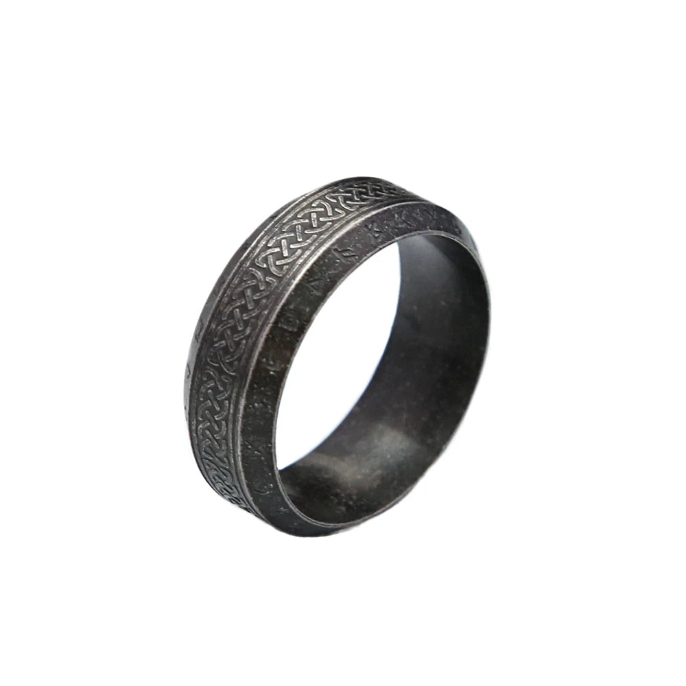Dark grey metal ring with intricate Viking knot design on a white background
