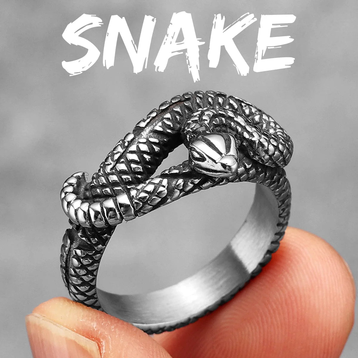 Silver snake-shaped ring held by a finger against a grey background with 'SNAKE' text.
