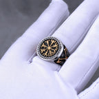 Silver ring with intricate Viking design on a white glove