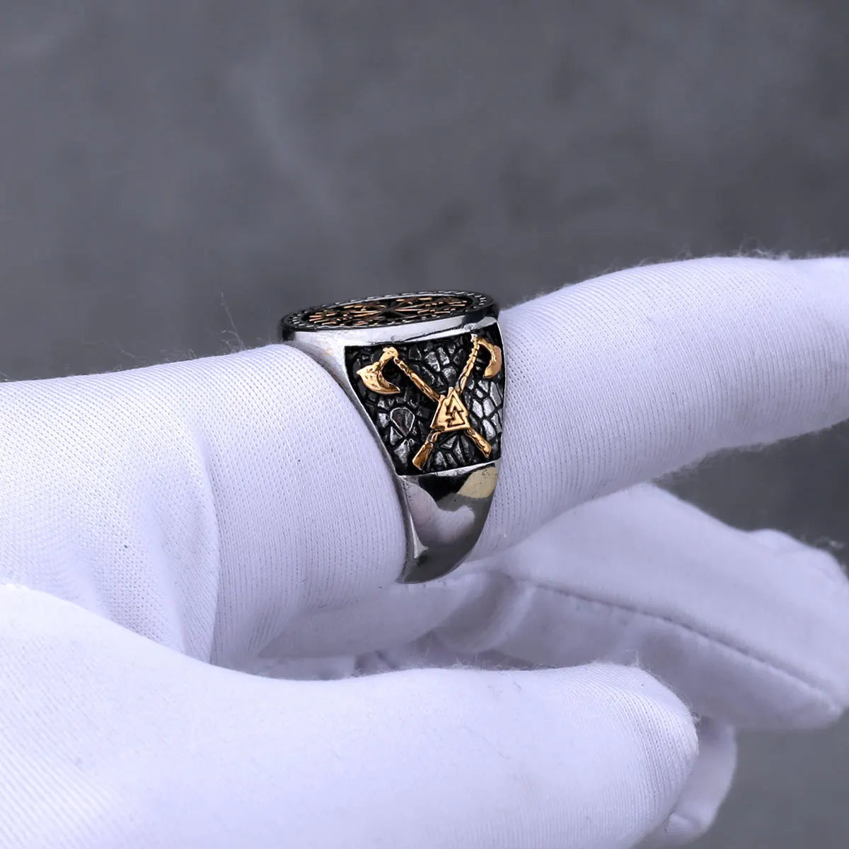 Viking ring with gold colour on a white glove