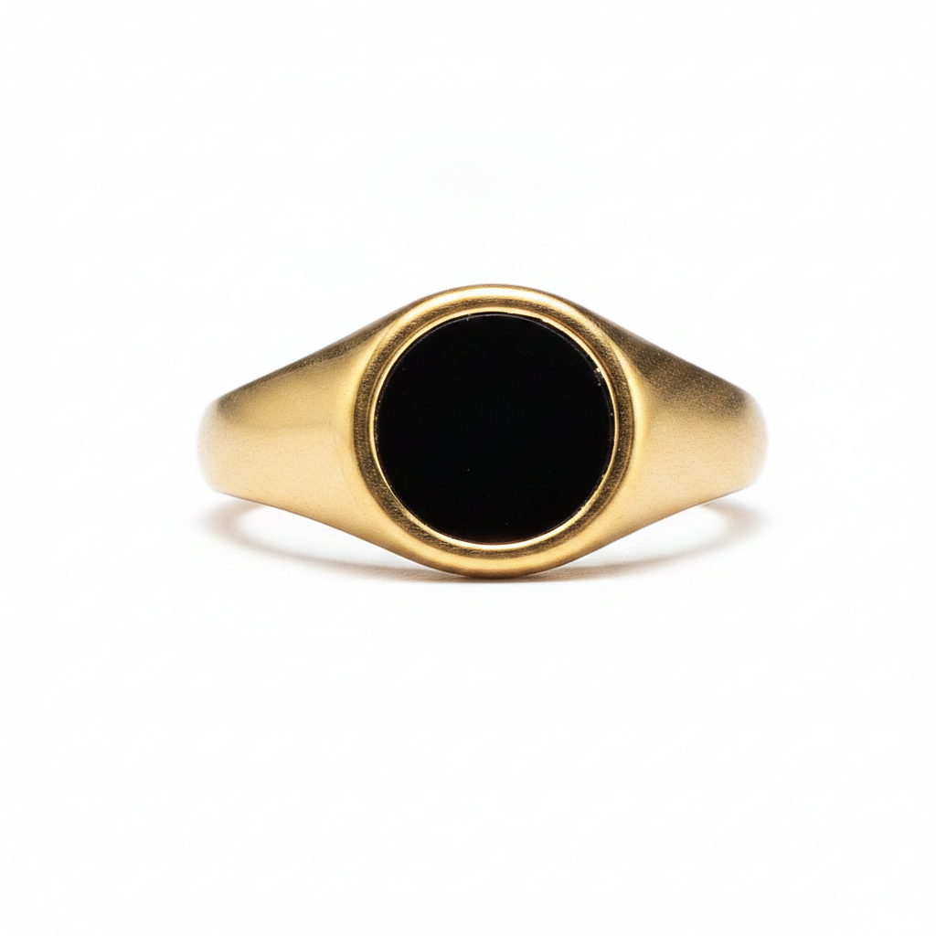Gold signet ring with a black flat stone-like design on a white background