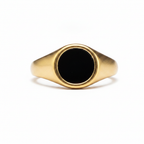 Gold signet ring with a black flat stone-like design on a white background