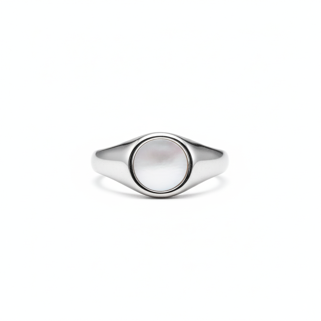 Silver ring with a circular shell flat pearl design on a white background