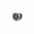 A silver and gold Viking signet ring with a intricate Vegvisir design on a dark grey granite stone surface