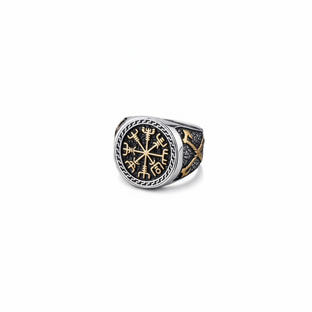 A silver and gold Viking signet ring with a intricate Vegvisir design on a dark grey granite stone surface