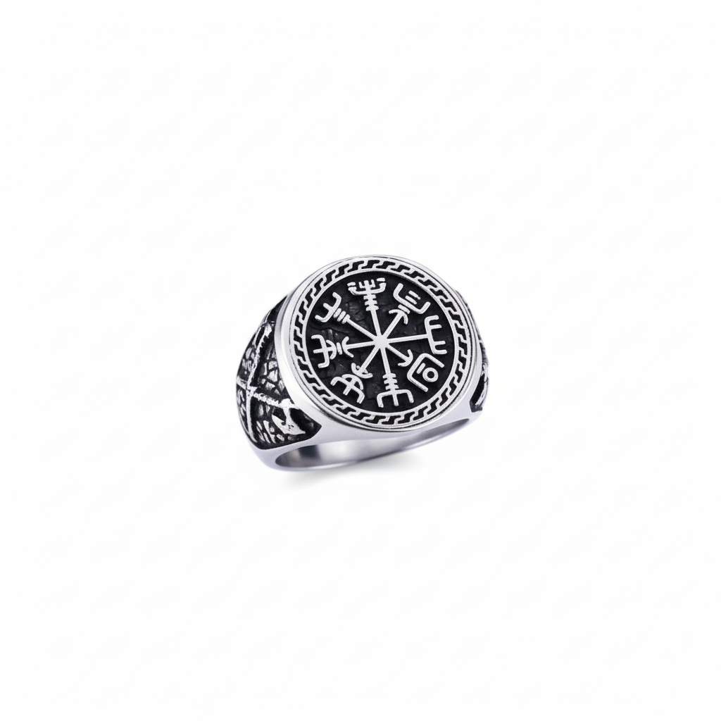 A silver Viking signet ring with a intricate Vegvisir design on a dark grey granite stone surface