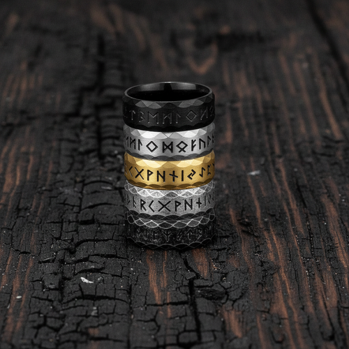rings with Noridc Runes on a textured dark surface